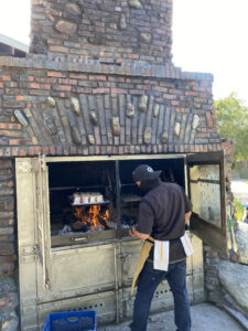 The Grill's Chef Placing Oxtails in the Chimney Smoker