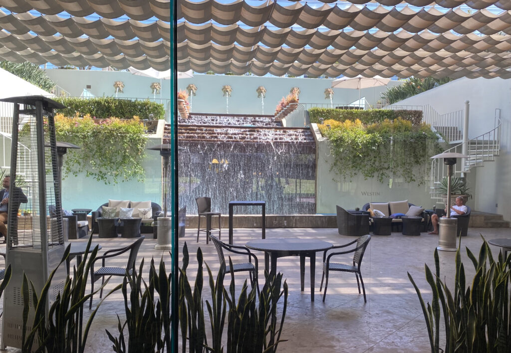 View of patio area with Neptune waterfall spouts inside the Westin South Coast Plaza