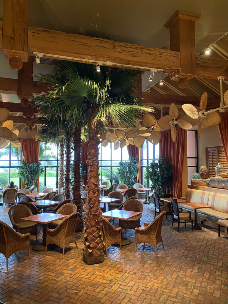 Grotto Bay Tropical Lounge with Wicker Furniture and large Bermuda ceiling fans