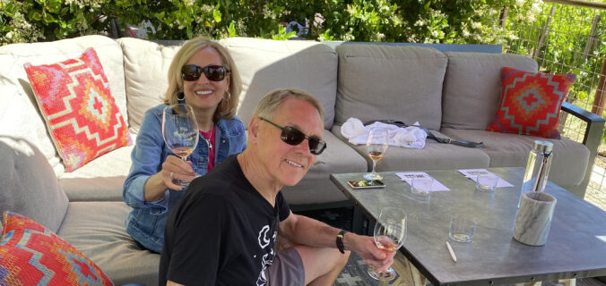 Rita and Ken Person enjoying a wine tasting in a private outdoor seating at Hope Family Wines