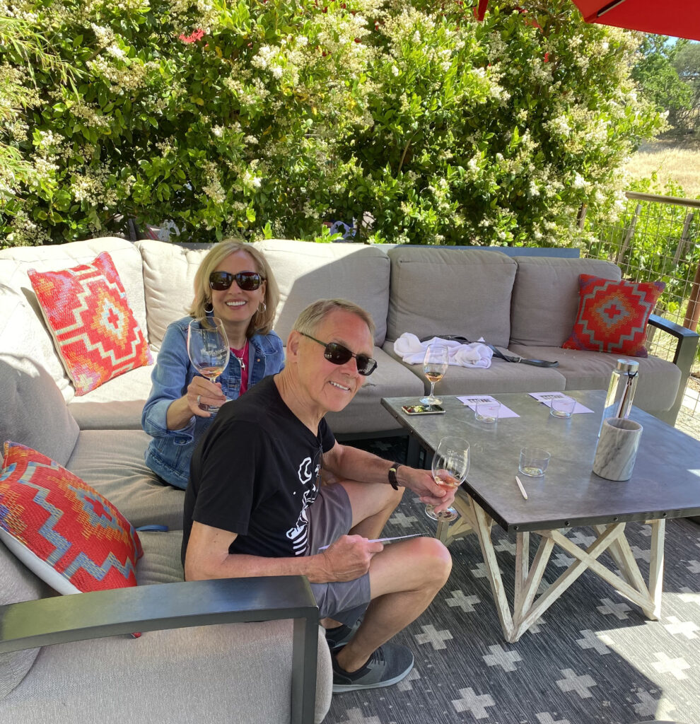 Rita and Ken Person enjoying a wine tasting in a private outdoor seating at Hope Family Wines