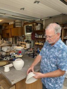 Potters Vineyard owner Bill Sanchez holding a piece of clay greenware in his art studio