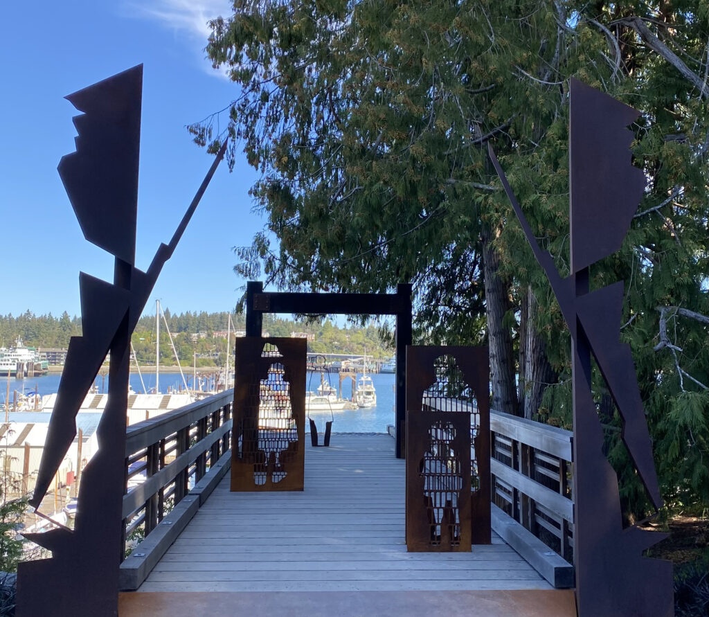 Metal sculpture of a guard holding a rifle and bayonet at the boat dock where the Japanese Americans were forced to leave Bainbridge Island