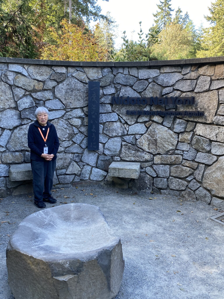 Lilly Kitamoto, our guide in front of the Japanese American Exclusion Memorial stone wall