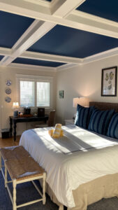 White beamed ceiling with painted blue squares to match the blue and white bedroom at Inn at Pleasant Beach