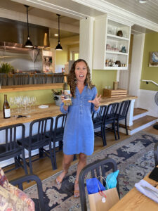 Brooke Huffman, owner of Social Sip, holding a Washington wine