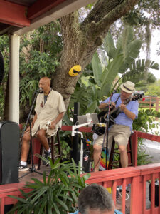 Blues group playing and singing at the end of the porch