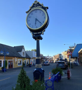 Clock in the center of Poulsbo with the City of Poulsbo on it and Main Street in background in backgr
