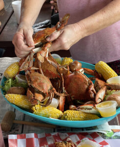Blue crab being cracked in crab boil at Peace River Seafood Restaurant