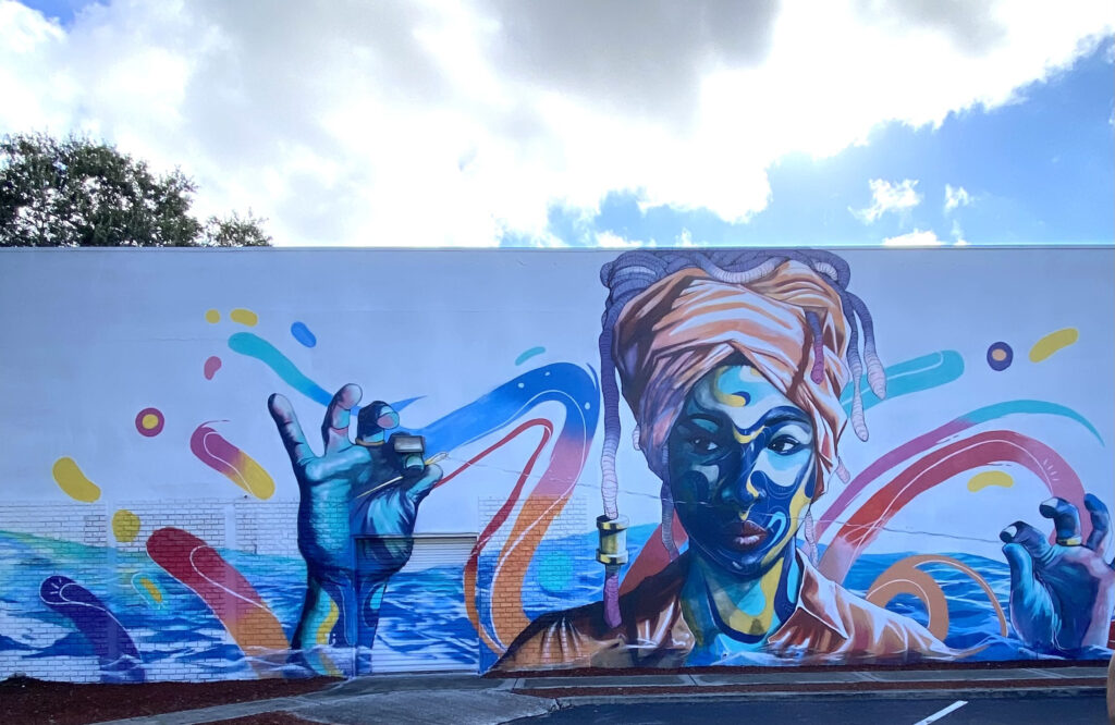 Mural painted on side of a building of an woman with headscarf