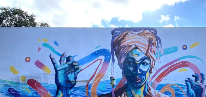 Mural painted on side of a building of an woman with headscarf