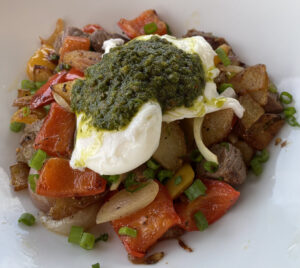 Cardiff Crack made of Cardiff's famous black pepper tri-tip, potato, and poached egg with chimichurri on top