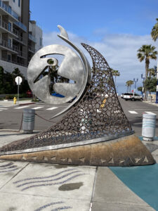 Last Wave of the Day metal sculpture of a surfer on a wave by Steven Rieman
