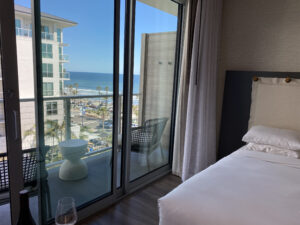 View looking out the sliding patio door at the beach and Pacific Ocean