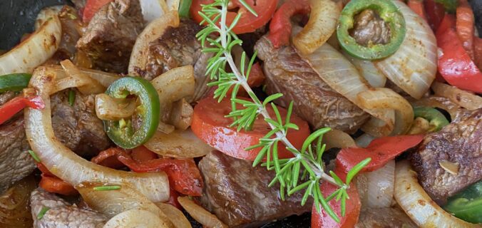 Tibs, a beef stir fry of beef, onions, tomatoes, red peppers, garlic, and jalapenos.