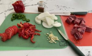 Tibs prep with beef, tomatoes, red peppers, onions, garlic, and berbere