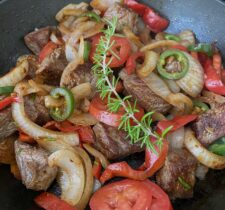 Tibs, a beef stir fry of beef, onions, tomatoes, red peppers, garlic, and jalapenos.