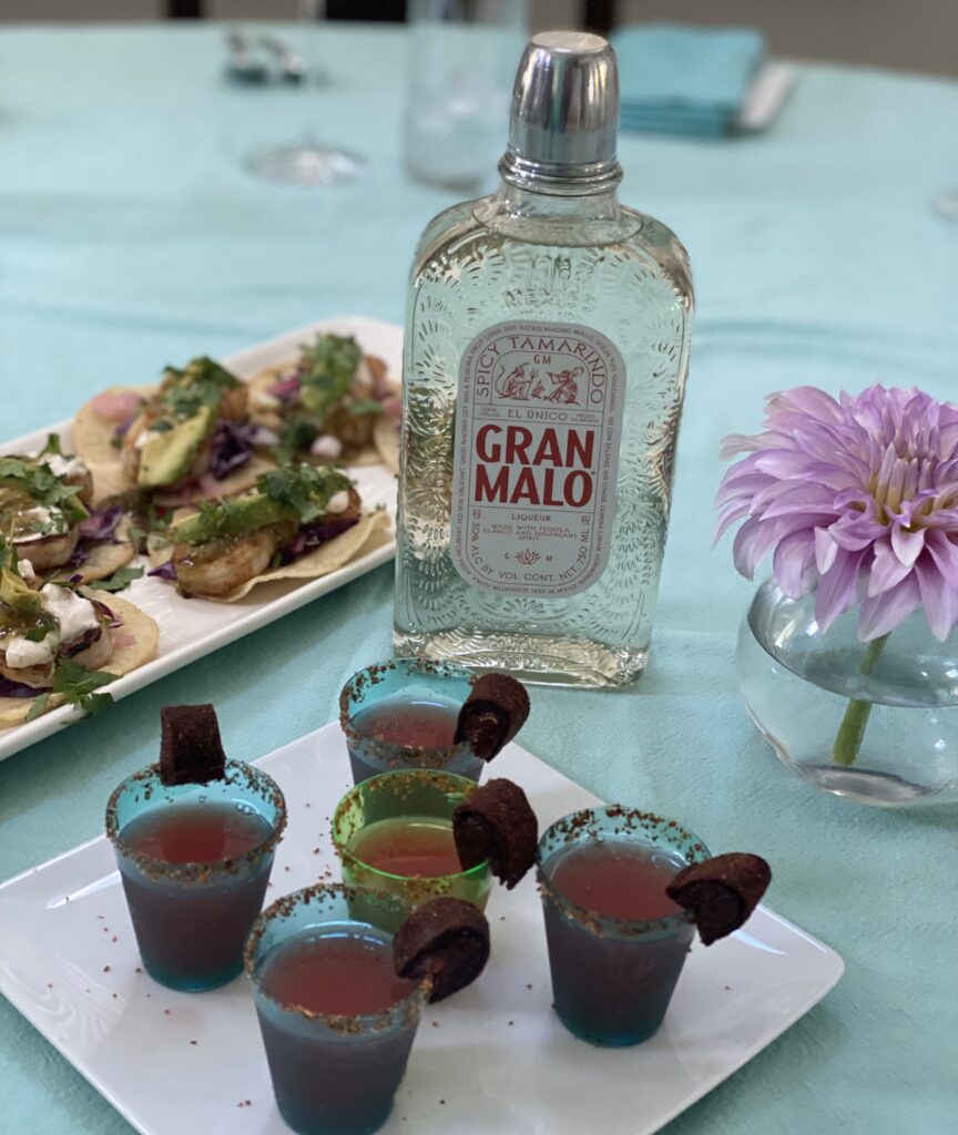 Mexican Candy Shot of Gran Malo and watermelon served with Baja Shrimp Street Tacos