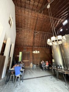 Hermann J Wiemer Vineyards Tasting next to the huge aluminum fermentation barrels